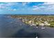 Overhead view of waterfront homes with docks extending into the water and trees surrounding the neighborhood at 1302 5Th W St, Palmetto, FL 34221