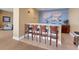 Resident bar area with a bar-height counter, comfortable seating, and neutral finishes for a relaxed social atmosphere at 140 Riviera Dunes Way # 1203, Palmetto, FL 34221