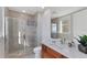 Well-lit bathroom featuring a glass-enclosed shower, granite counters, and a modern design at 140 Riviera Dunes Way # 1203, Palmetto, FL 34221