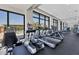 Modern gym with cardio machines and treadmills, offering a view of the community pool at 140 Riviera Dunes Way # 1203, Palmetto, FL 34221