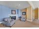Comfortable lounge area with a fireplace, two armchairs, and tranquil artwork creating a peaceful space to relax and unwind at 140 Riviera Dunes Way # 1203, Palmetto, FL 34221