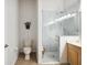 Modern bathroom features a glass-enclosed shower and a toilet, complemented by a decorative wall hanging at 14150 Cattle Egret Pl, Lakewood Ranch, FL 34202