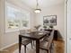 Inviting dining room featuring hardwood floors, large window, and elegant decor, ideal for Gathering meals at 14150 Cattle Egret Pl, Lakewood Ranch, FL 34202