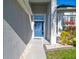 Inviting entryway features a stylish blue front door and well-maintained landscaping at 14150 Cattle Egret Pl, Lakewood Ranch, FL 34202