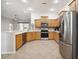 Well-lit kitchen featuring stainless steel appliances, ample counter space, and seamless flow to living areas at 14150 Cattle Egret Pl, Lakewood Ranch, FL 34202