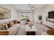 Bright living room with neutral tones, stylish furnishings, and sliding glass doors leading to outdoor view at 14150 Cattle Egret Pl, Lakewood Ranch, FL 34202