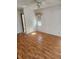 Cozy bedroom with wood floors and a ceiling fan, offering comfort and style at 1472 Nantucket Rd, Venice, FL 34293