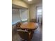 Breakfast nook with wood table, padded chairs, bay windows, and laundry access at 1472 Nantucket Rd, Venice, FL 34293