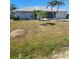 Inviting single-story home with well-manicured lawn and palm trees, enhanced by dolphin art at 1472 Nantucket Rd, Venice, FL 34293