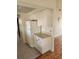 Kitchen featuring white cabinets, countertops, and appliances, with tile and wood floors at 1472 Nantucket Rd, Venice, FL 34293