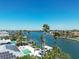 Beautiful aerial view of a waterfront property featuring a private dock, pool, and solar panels at 148 N Polk, Sarasota, FL 34236