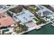 Aerial view of waterfront home with boat dock, swimming pool, and lush landscaping at 148 N Polk, Sarasota, FL 34236