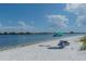 Beautiful beach view with white sand, blue water, picnic table and chairs at 148 N Polk, Sarasota, FL 34236