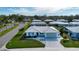 An aerial view highlighting the lush landscaping and pristine roofing of this home at 1511 S Knollwood Dr, Bradenton, FL 34208
