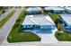 An aerial view shows the home's pristine roof, landscaping, and proximity to other homes in the neighborhood at 1511 S Knollwood Dr, Bradenton, FL 34208