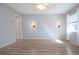 Bedroom with wood-look flooring, sconces, and view of the yard at 1511 S Knollwood Dr, Bradenton, FL 34208