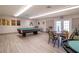 The billiard room features a pool table, chairs, and plenty of space for residents to enjoy at 1511 S Knollwood Dr, Bradenton, FL 34208