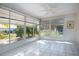 Sunny bonus room with tile floors and large windows overlooking tropical landscaped yard at 1511 S Knollwood Dr, Bradenton, FL 34208