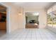 Bright bonus room featuring tile flooring and access to the outdoor lanai and living spaces at 1511 S Knollwood Dr, Bradenton, FL 34208