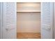 Walk-in closet with bifold doors, wood-look flooring, and plenty of storage space at 1511 S Knollwood Dr, Bradenton, FL 34208