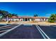 Clubhouse featuring a terracotta roof, mature palm trees, and ample parking at 1511 S Knollwood Dr, Bradenton, FL 34208