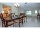 Dining area with a glass-top table and chairs, seamlessly connecting to the kitchen and living spaces at 1511 S Knollwood Dr, Bradenton, FL 34208