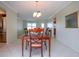 Chandelier illuminated dining room featuring table with 6 chairs and seamless flow into the kitchen and living room at 1511 S Knollwood Dr, Bradenton, FL 34208