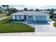 Well-maintained single-story home with an attached garage, manicured lawn, and complemented by a white picket fence at 1511 S Knollwood Dr, Bradenton, FL 34208