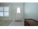 Bright and airy foyer featuring tiled floors, a window with shutters, and a classic white paneled front door at 1511 S Knollwood Dr, Bradenton, FL 34208