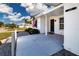 Inviting covered entry featuring a tiled porch and a well-maintained exterior with neatly arranged landscaping at 1511 S Knollwood Dr, Bradenton, FL 34208