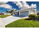 Well-maintained single-story home with an attached garage, complemented by a manicured lawn and mature landscaping at 1511 S Knollwood Dr, Bradenton, FL 34208