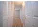 Hallway area with wood-look flooring, white doors and access to living areas at 1511 S Knollwood Dr, Bradenton, FL 34208