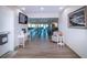 Hallway featuring vinyl floors, seating, and a TV with views into large gathering room at 1511 S Knollwood Dr, Bradenton, FL 34208