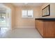 Neutral wall paint and tile floors highlight the natural wood cabinets in this kitchen at 1511 S Knollwood Dr, Bradenton, FL 34208