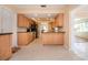 Spacious kitchen features wood cabinets, black appliances and counters, and tile flooring at 1511 S Knollwood Dr, Bradenton, FL 34208
