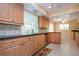 Bright kitchen area with stainless steel appliances, wooden cabinets, and tile flooring at 1511 S Knollwood Dr, Bradenton, FL 34208