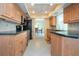 Bright kitchen boasts wood cabinets, stainless steel appliances, and tile flooring at 1511 S Knollwood Dr, Bradenton, FL 34208