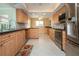 Wide angle shot of spacious kitchen with stainless steel appliances and tile flooring at 1511 S Knollwood Dr, Bradenton, FL 34208