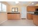 Traditional kitchen with natural wood cabinets, tile flooring, black counters, and white door at 1511 S Knollwood Dr, Bradenton, FL 34208