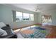 Light-filled living room with laminate flooring, ceiling fan, and expansive windows overlooking the neighborhood at 1511 S Knollwood Dr, Bradenton, FL 34208