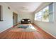 Cozy and airy living room with large windows, laminate flooring and bonus room access at 1511 S Knollwood Dr, Bradenton, FL 34208