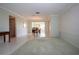 Open-concept living area showcasing tile and carpet flooring, with a dining area, and ample natural light at 1511 S Knollwood Dr, Bradenton, FL 34208