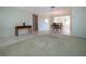 Inviting living area featuring neutral carpeting and tile, providing versatile space and seamless flow to other rooms at 1511 S Knollwood Dr, Bradenton, FL 34208