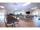 Meeting Room featuring tables and chairs, a large television, and an exit door at 1511 S Knollwood Dr, Bradenton, FL 34208