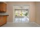 View of sunny sunroom with white-tiled floor and multiple windows from adjacent room at 1511 S Knollwood Dr, Bradenton, FL 34208