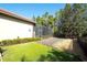 Landscaped backyard featuring a screened in patio and a grassy area at 15403 Leven Links Pl, Lakewood Ranch, FL 34202