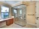 Bathroom featuring large shower area, stone tile, and a vanity at 15403 Leven Links Pl, Lakewood Ranch, FL 34202