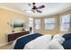 Serene bedroom with natural light, complemented by a stylish dresser and comfortable bedding at 15403 Leven Links Pl, Lakewood Ranch, FL 34202
