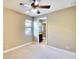 Bedroom showing neutral carpet and walls with a door leading to a connected bathroom at 15403 Leven Links Pl, Lakewood Ranch, FL 34202