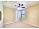 Bright bedroom featuring a ceiling fan, neutral walls and carpet, plus a window for natural light at 15403 Leven Links Pl, Lakewood Ranch, FL 34202